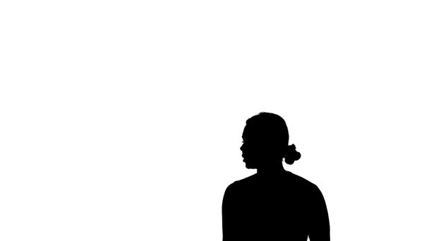 black silhouette on a white background, young beautiful girl dancer dancing contemporary, modern ballet dance, medium long shot - Záběry, video
