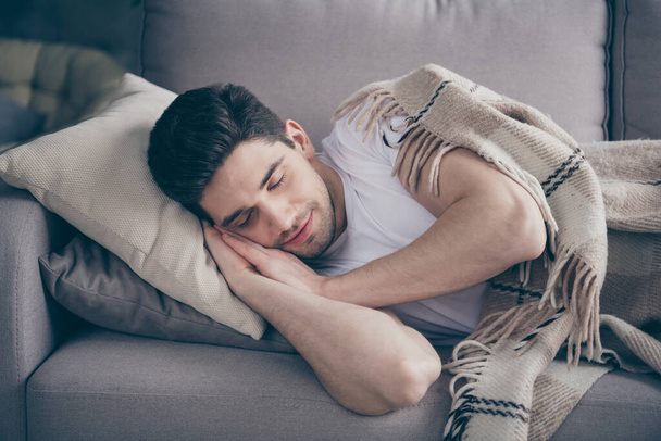 Close-up portrait of his he nice attractive peaceful brunette guy lying on divan sleeping resting healthy regime daily time in living-room indoors - Foto, immagini