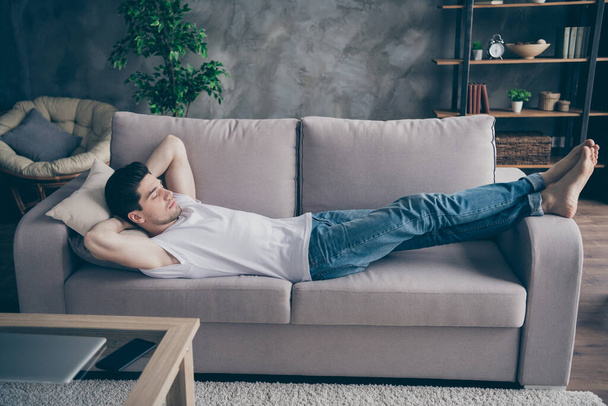 Profile side view portrait of his he nice attractive guy lying on divan sleeping resting pause break healthy regime at modern industrial loft brick interior style living-room - Photo, image