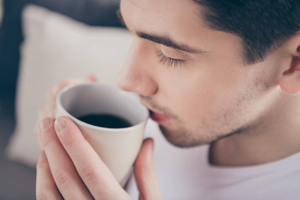 Cropped close-up portrait of his he nice attractive dreamy calm peaceful guy drinking cacao milk herbal useful tea herbs in living-room bedroom indoors - Фото, зображення