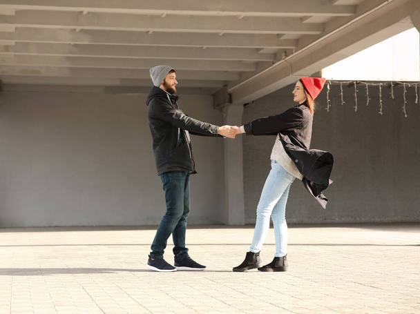Trendy hipster couple holding hands outdoors - Photo, image
