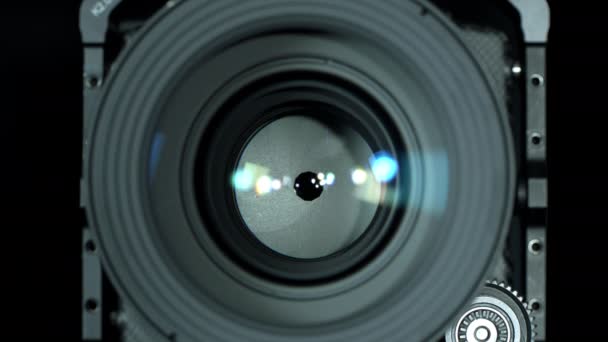Adjusting aperture of a professional camera lens, close-up. Opening and closing diaphragm, front view. Photography concept. Selective focus with shallow depth of field. - Footage, Video