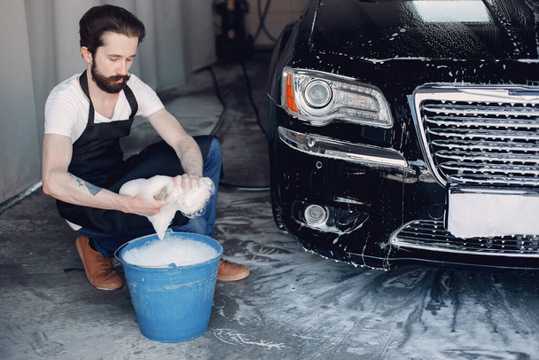 Man washing his car in a garage - Foto, Imagen