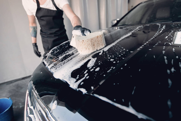 Man washing his car in a garage - Fotoğraf, Görsel