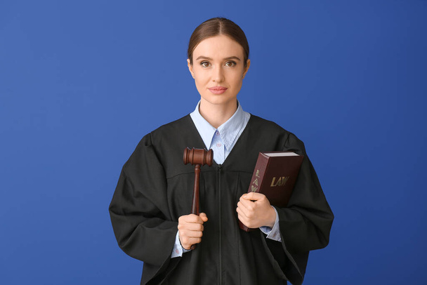 Female judge with book on color background - Photo, Image