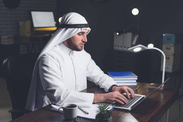 Arabische zakenman die 's avonds laat op kantoor werkt - Foto, afbeelding