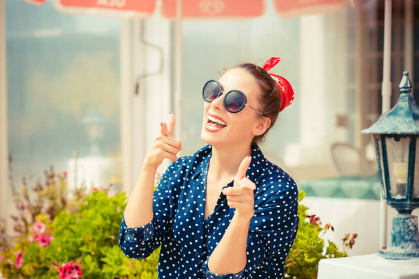 Hey you! Woman pointing at camera, point index finger gesture isolated sitting outdoors coffee shop on background. Human emotions, facial expressions, feeling, body language reaction - Foto, Imagen