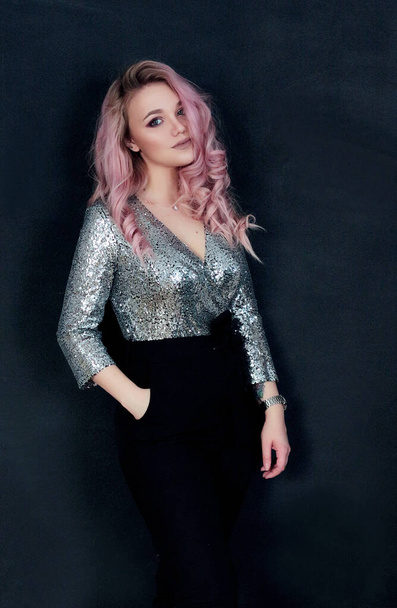 beautiful girl with pink hair on a black background in a Bunny mask and leather pants - Zdjęcie, obraz