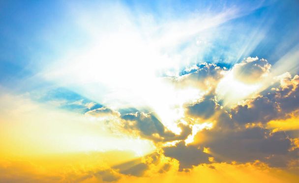 Bright light on color sky,bright sun beam light with yellow orange color in blue sky and clouds - Фото, изображение