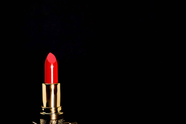 Red lipstick isolated on black background - Foto, imagen