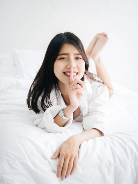 Happy Asian woman relaxing on bed, lifestyle concept. - Fotografie, Obrázek