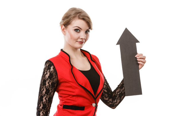 Make choice concept. Elegant woman in red with big black arrow sin symbol pointing. Young girl present show right direction to decide and solve problems. - Foto, imagen