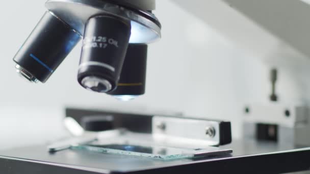 Close-up of scientific microscope. Laboratory in hospital. Epidemic disease, healthcare, vaccine research and coronavirus 2019-ncov test concept. - Filmati, video