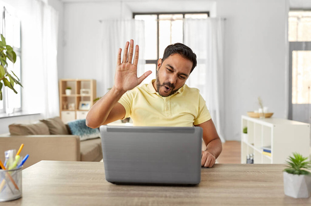 man with laptop has video chat and makes high five - Foto, imagen