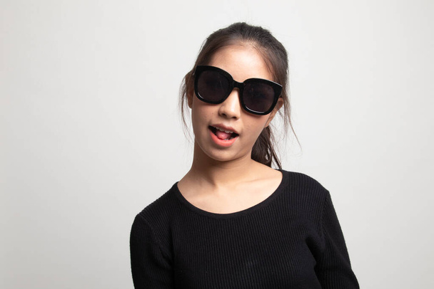 Portrait of a beautiful young asian girl in sunglasses on white background - Zdjęcie, obraz