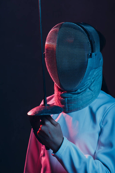 Fencer woman with fencing epee saber sword. Color light. - Photo, Image