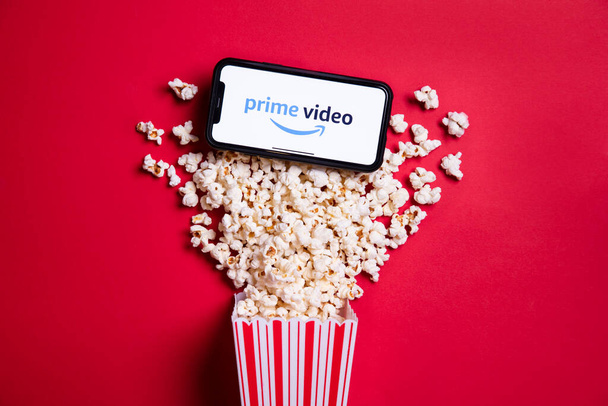LONDON, UK - MAY 14 2020: Amazon Prime video logo on a smartphone with popcorn - 写真・画像