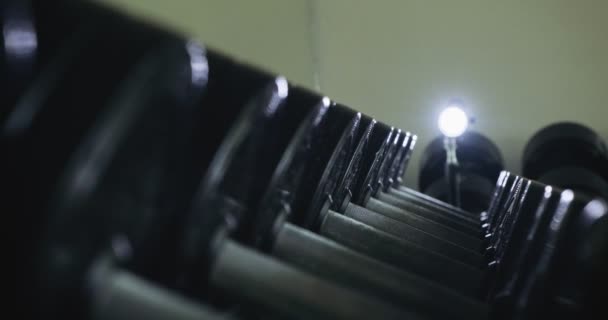Dumbbells row in modern sport club gym. Close up of sport equipment - Footage, Video