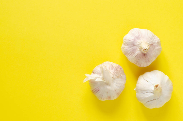 organic garlic on yellow background with copy space. Top view - Fotó, kép