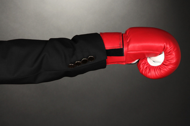Businessman in boxing gloves on grey background - Photo, Image