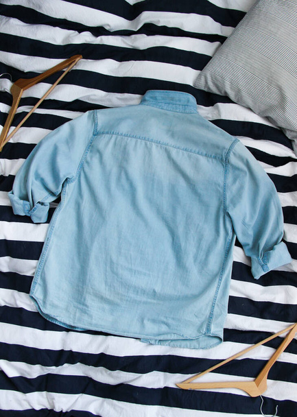 Faded blue denim jacket. Denim jacket back mockup over striped background.  - Photo, Image