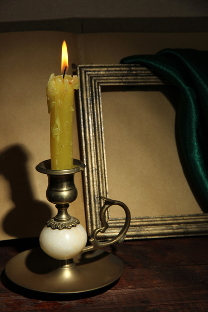 Old candle on table in room - Φωτογραφία, εικόνα