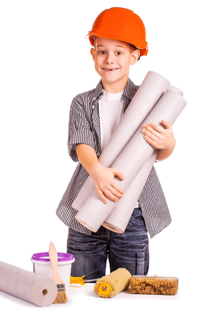 Cute boy with a roll of wallpaper and brush. isolated - Foto, imagen