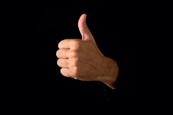 Thumb up on dark background - Foto, afbeelding