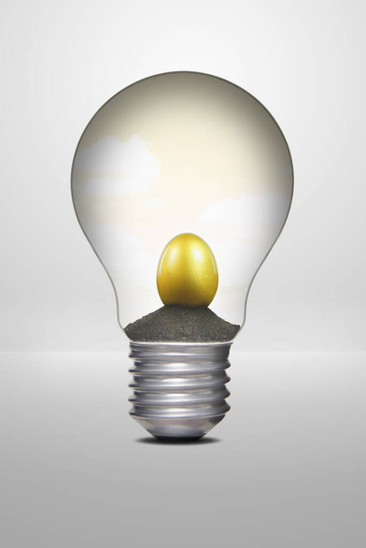 Golden egg placed inside a light bulb - Φωτογραφία, εικόνα