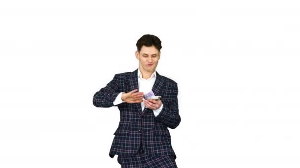 Man in formal suit walking in and throwing money in the air on white background. - Záběry, video