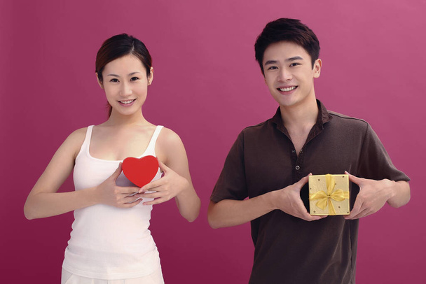 Man and woman holding gift boxes - 写真・画像