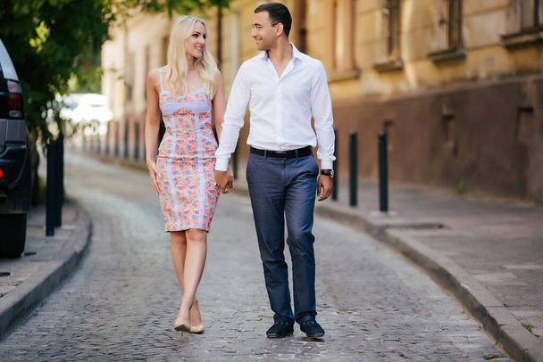 beautiful couple on city background posing, full height - Fotó, kép