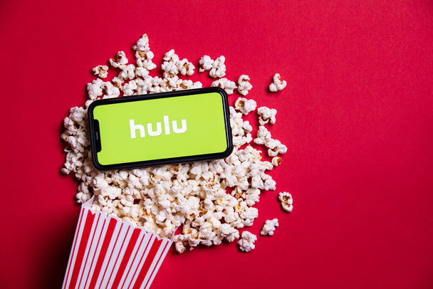 LONDON, UK - MAY 14 2020: Hulu logo on a smartphone with popcorn - Фото, зображення