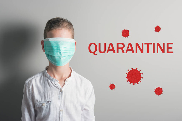 Boy in a medical mask on his face with red inscription QUARANTINE on bright background. Epidemic virus 2019-nCoV Respiratory Syndrome. Medicine concept. - Foto, immagini