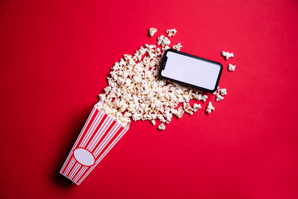 LONDON, UK - MAY 14 2020: Apple iphone blank screen with cinema popcorn - Photo, Image