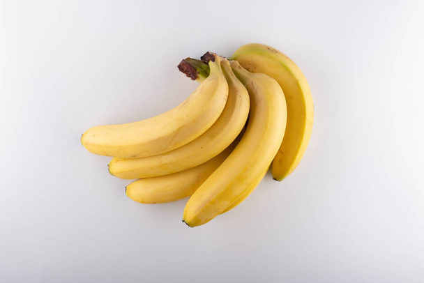 bunch of ripe bananas on a white background close-up - Photo, Image