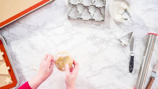 Flat lay. Rolling out sugar cookie dough to bake Christmas cookies. - Photo, Image