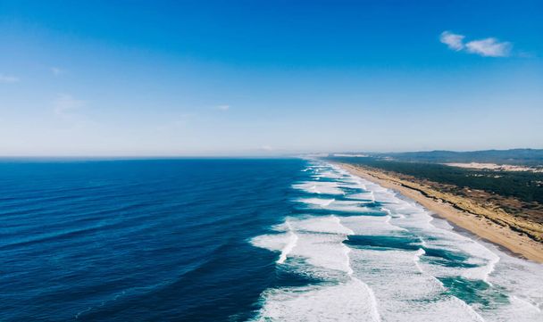 Aerial breathtaking view of wonderful nature landscape, Bird's eye view seashore with big foamy waves with turquoise water in coastal environment. Pacific ocean power, sandy beach of California  - Φωτογραφία, εικόνα
