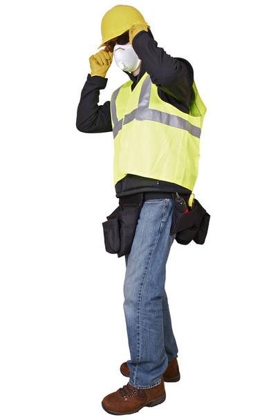 Construcción Hombre trabajador con máscara de seguridad casco duro chaleco reflectante y correa de herramientas
.  - Foto, imagen