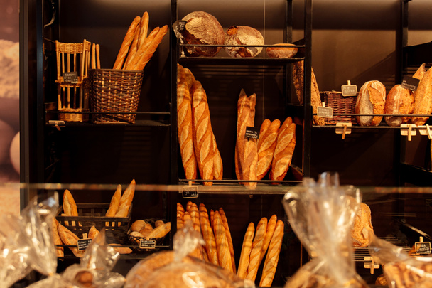Selective focus of baguettes and bread on bakery showcase in Catalonia, Spain  - Fotoğraf, Görsel