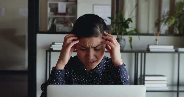 Frustrated overwhelmed young indian business woman feels headache or stress working on computer sitting in office - Filmmaterial, Video