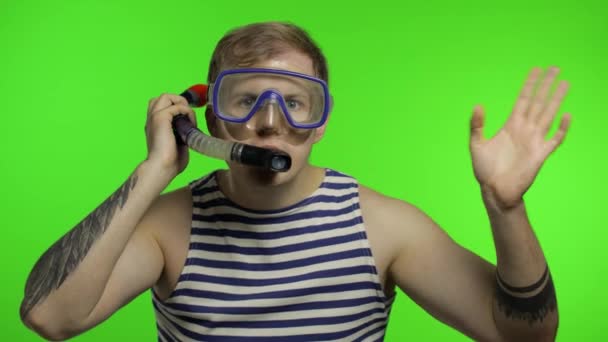 Emotional man tourist in underwater mask waving hands, striped sailor shirt - Footage, Video