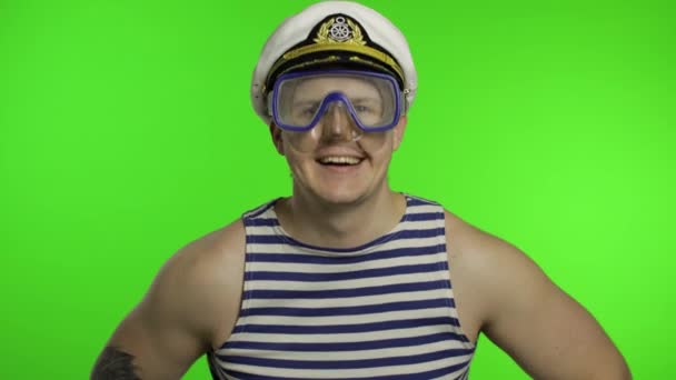Emotional man tourist in underwater mask waving hands, striped sailor shirt - Footage, Video