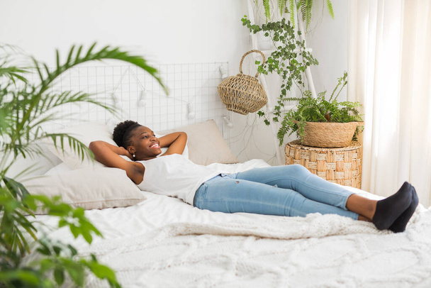  beautiful young african woman sleeping on a white bed - Photo, image