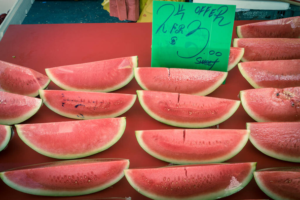 Découpes savoureuses de pastèque en film adhésif avec des étiquettes de prix sur le stand du marché à Singapour. Fruits tropicaux d'été dans une pellicule plastique pour plus de commodité à emporter collations saines
 - Photo, image