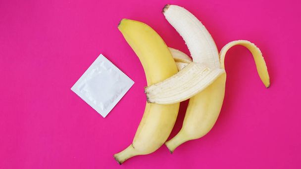 Condoms and two bananas together, concept of contraceptives and the prevention - Foto, Imagen