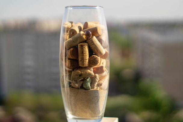 Glass vase with corks, sand and shells - Zdjęcie, obraz
