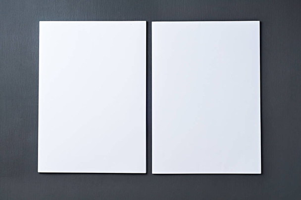 Two stacks of whole blank white paper sheets lies on dark concrete table on workplace of secretary, director, boss or other worker of company. Space for text. Top view. Close-up - Foto, afbeelding