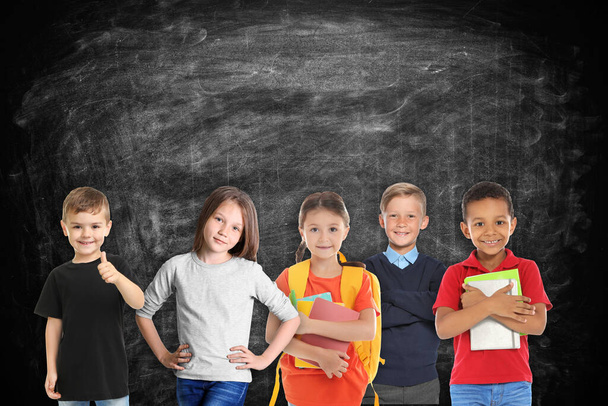 Group of cute school children and chalkboard on background - Zdjęcie, obraz