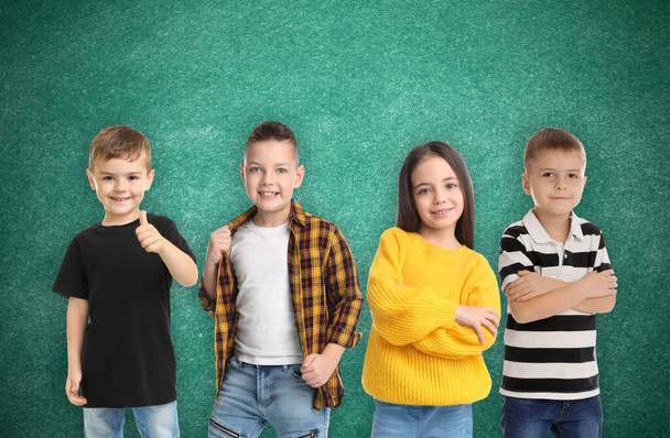 Group of cute school children and chalkboard on background - Foto, Bild